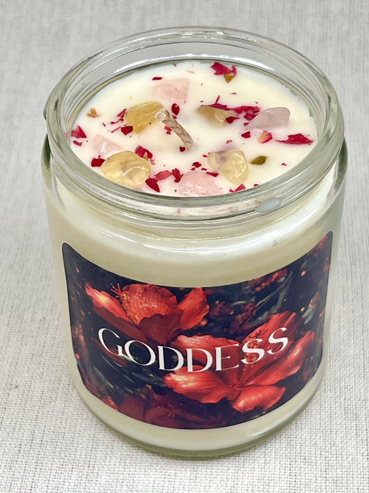 Candle in a glass jar with decorative label on a textured surface