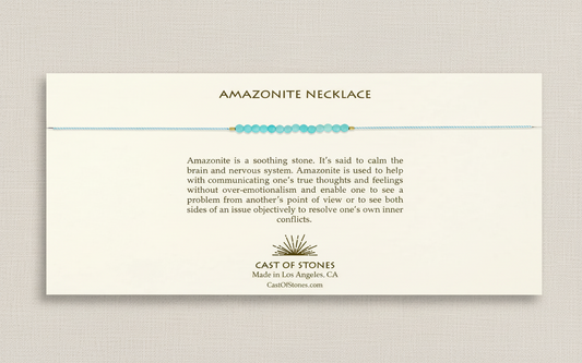 Amazonite necklace on a white card with product description and brand information.