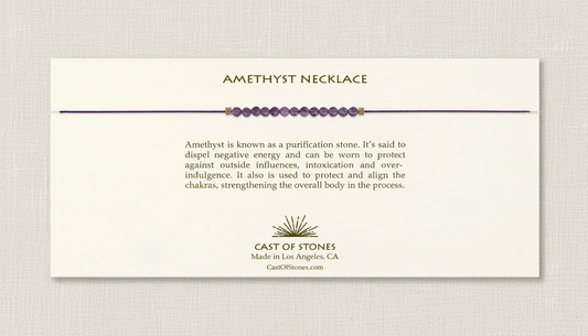 Amethyst necklace on a beige card with product description and brand information.