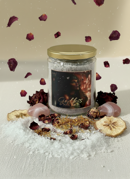 Jar of Goddess Bath salt with decorative elements on a textured surface