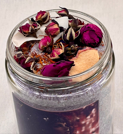 Jar filled with dried flowers and herbs on a light background