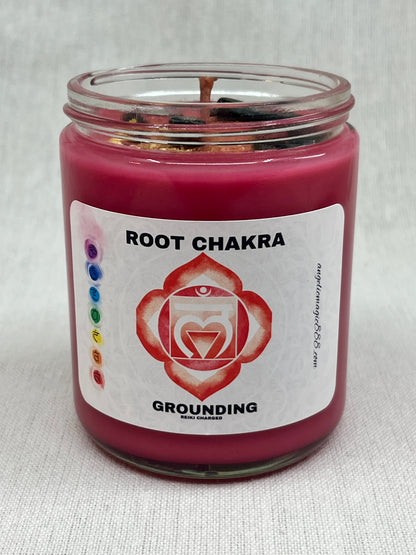 Red candle in a glass jar with a label indicating 'Root Chakra' and 'Grounding'.