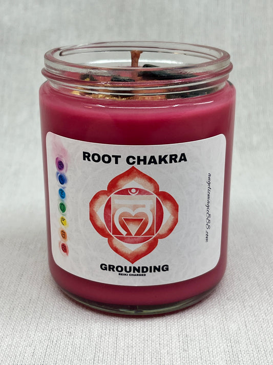 Red candle in a glass jar with a label indicating 'Root Chakra' and 'Grounding'.