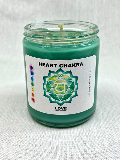 Green candle in a glass jar with a 'Heart Chakra' label on a white background