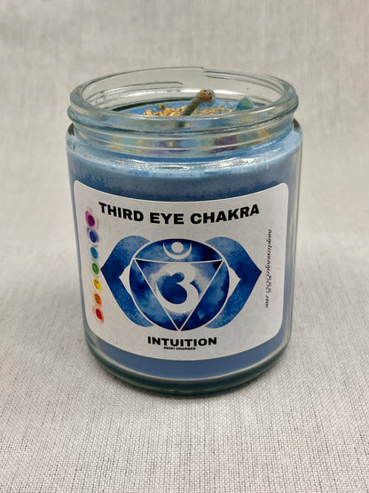 Blue candle in a glass jar with a label indicating 'Third Eye Chakra' and 'Intuition'.