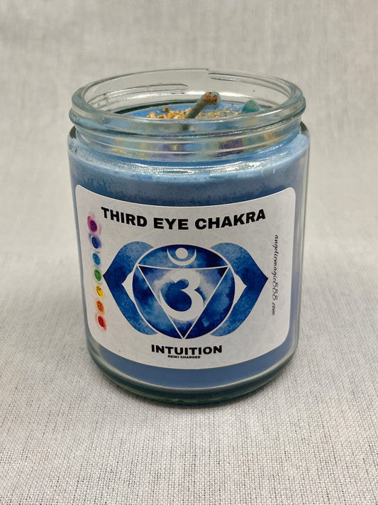 Blue candle in a glass jar with a label indicating 'Third Eye Chakra' and 'Intuition'.