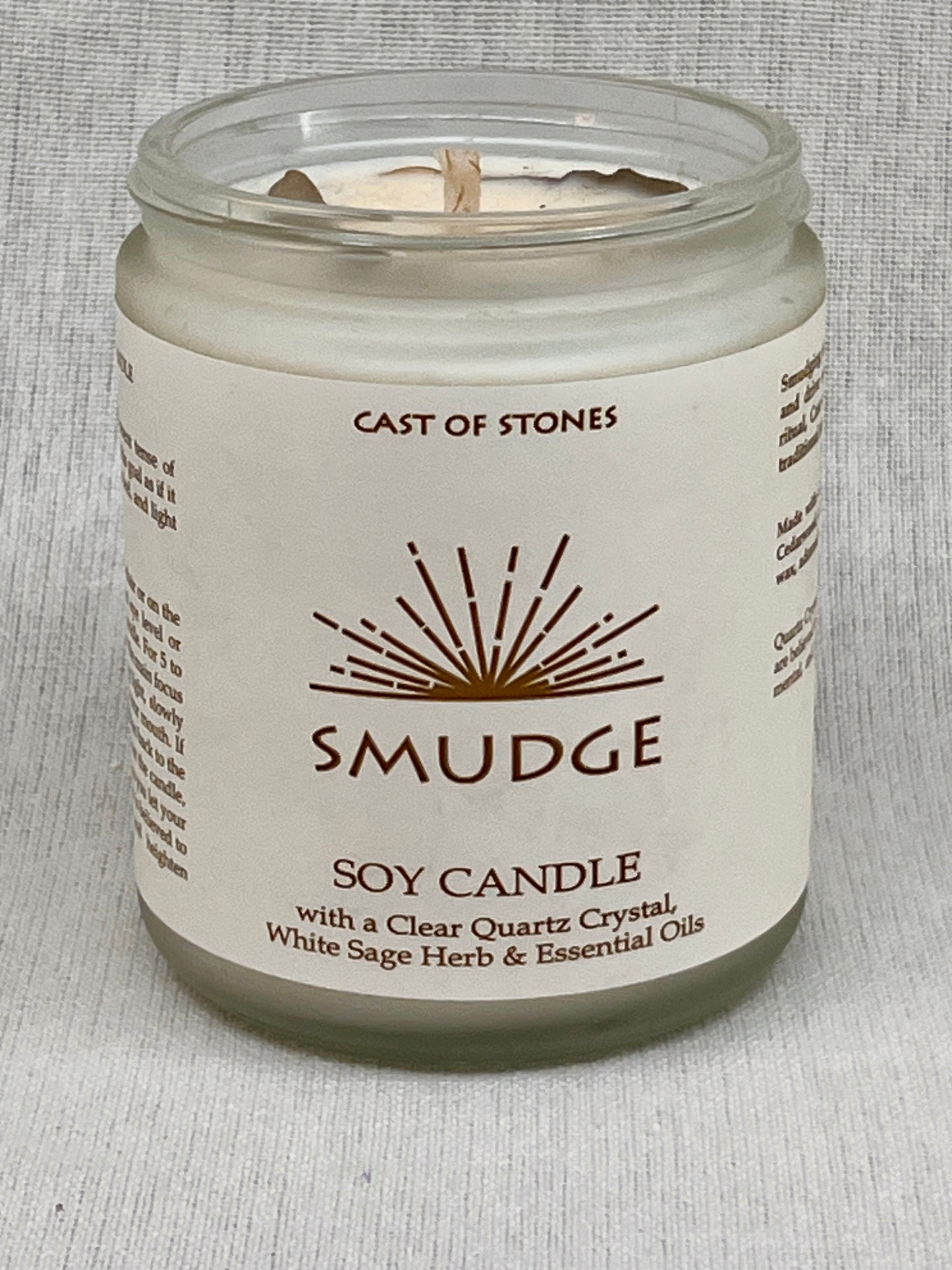 Soy candle in a glass jar with a label on a gray background