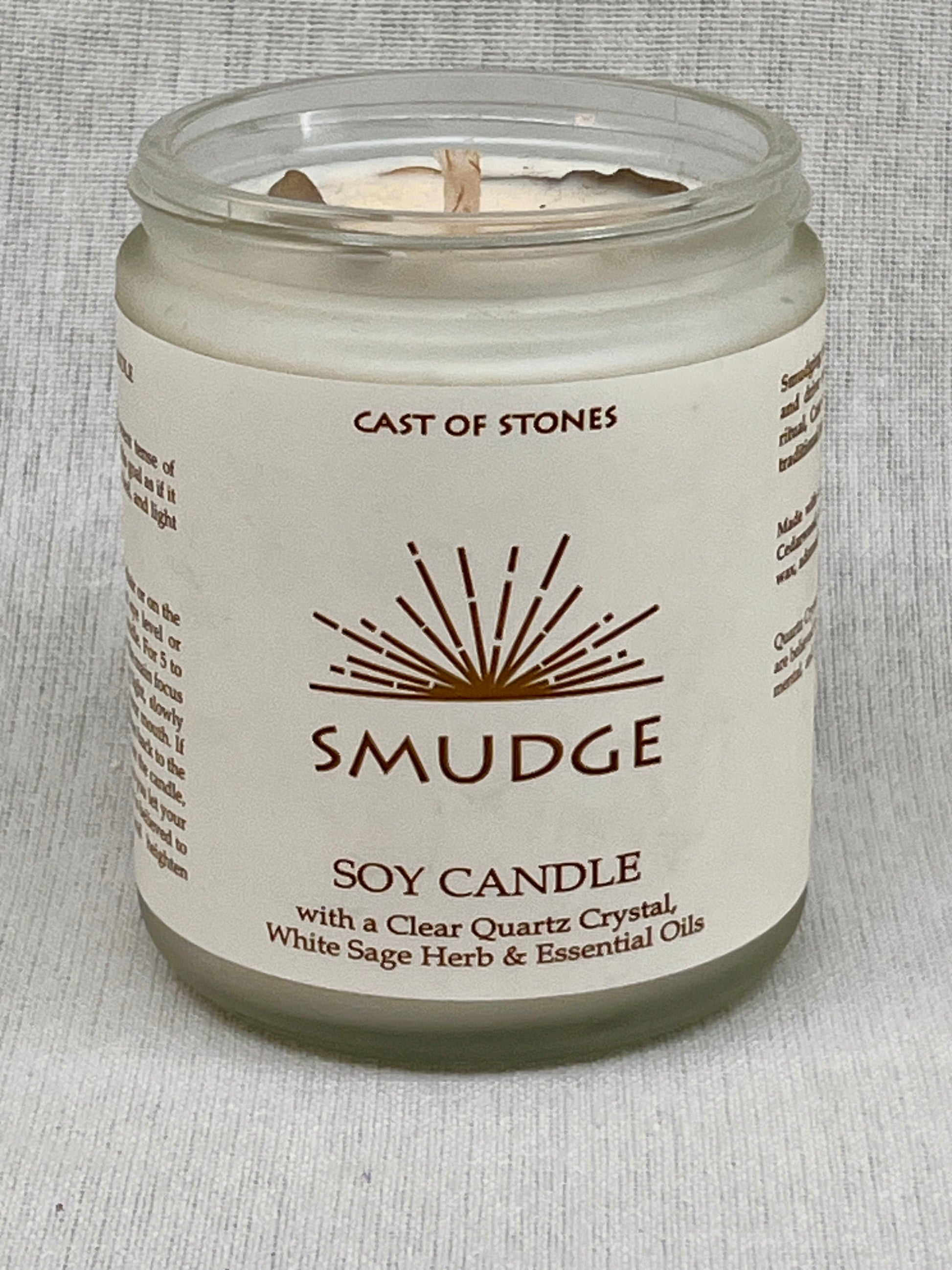 Soy candle in a glass jar with a label on a gray background
