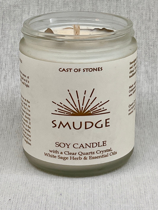 Soy candle in a glass jar with a label on a gray background