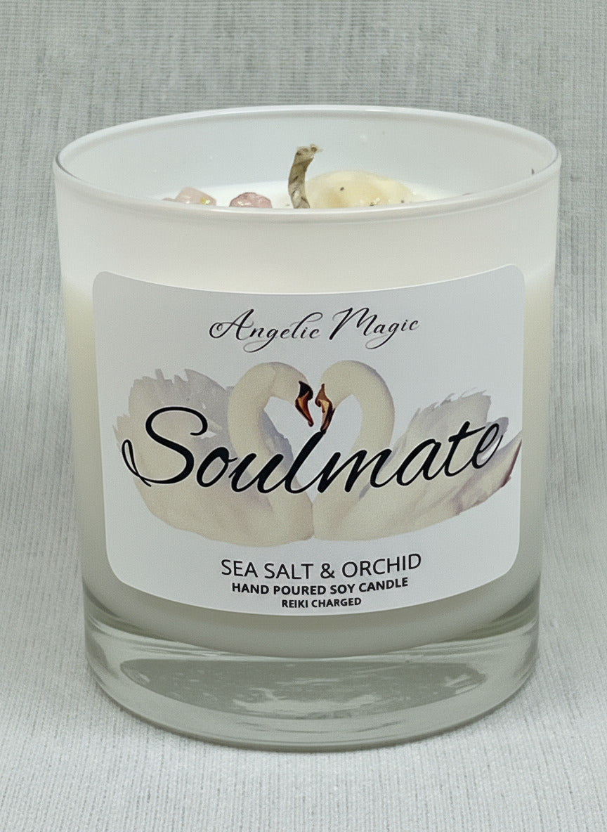 Candle with a label featuring a swan design and text on a gray background