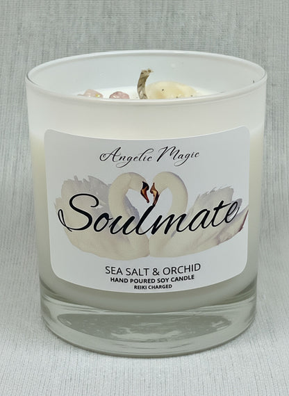 Candle with a label featuring a swan design and text on a gray background