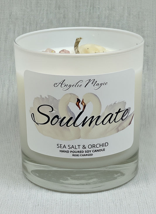 Candle with a label featuring a swan design and text on a gray background