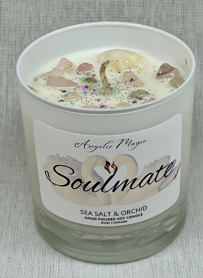 Candle labeled 'Soulmate' with sea salt and orchid fragrance on a textured surface