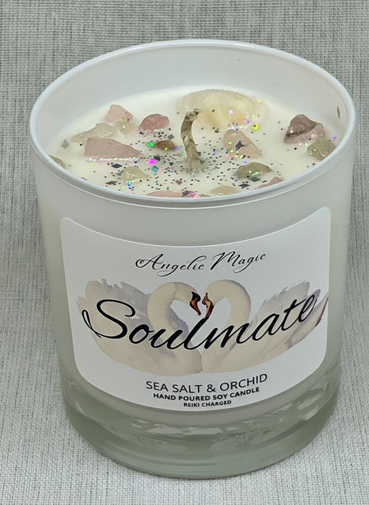 Candle labeled 'Soulmate' with sea salt and orchid fragrance on a textured surface