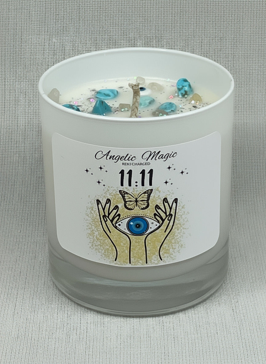 Candle with a label featuring angelic design and text on a gray background