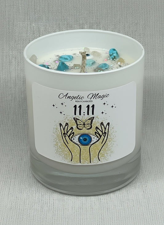 Candle with a label featuring angelic design and text on a gray background