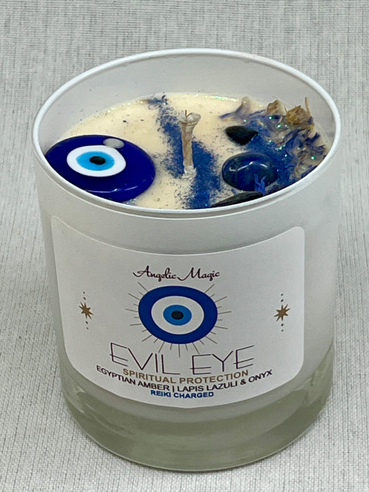 Candle with evil eye design and angelic magic label on a gray background
