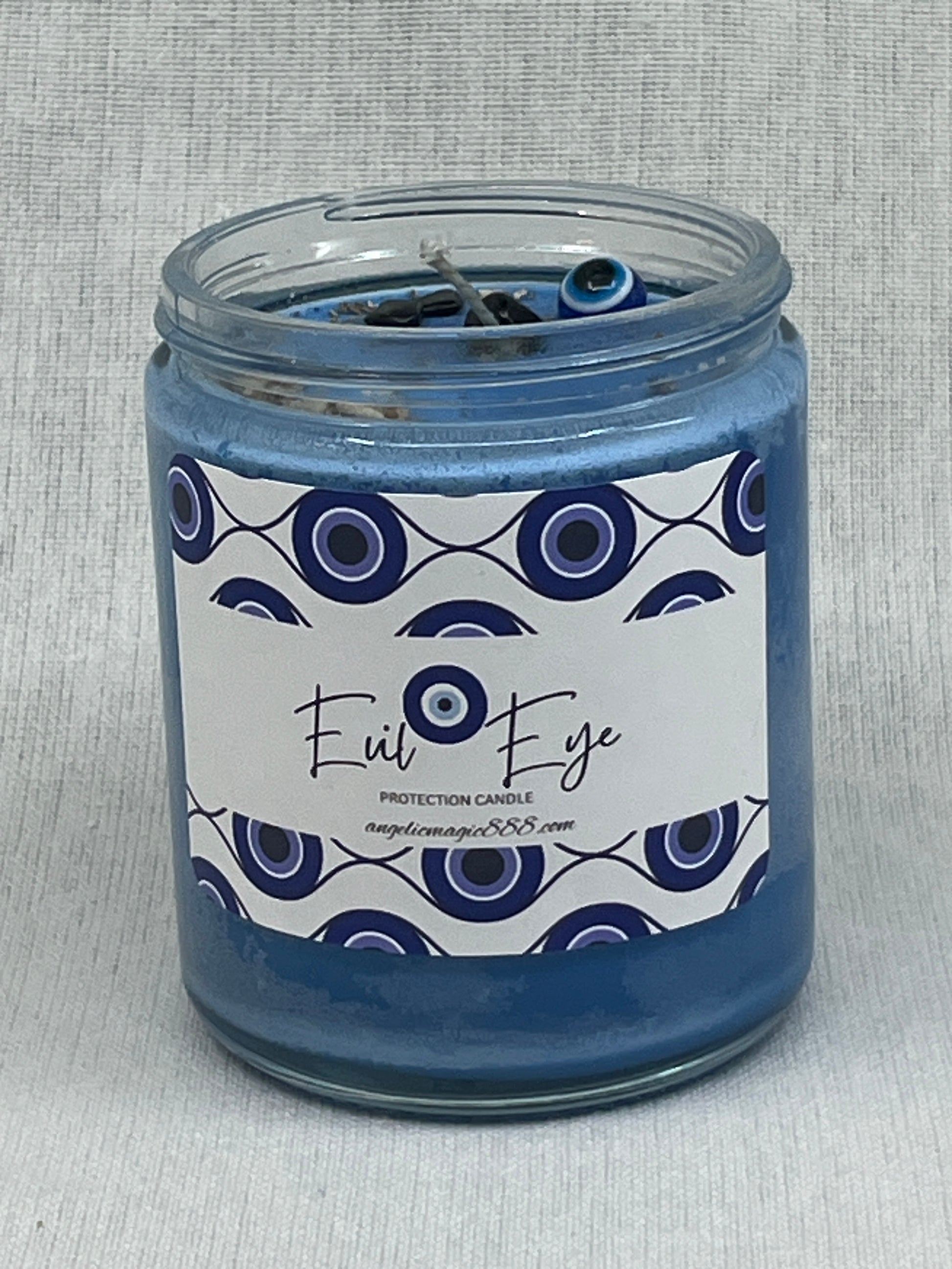 Jar candle with a decorative label on a textured gray background