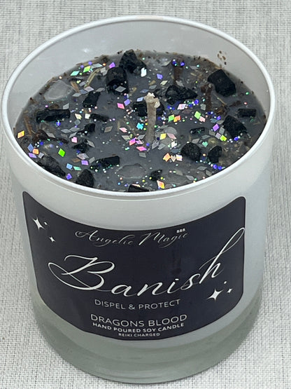 Decorative candle container with 'Banish' label and colorful glitter inside, on a textured surface.