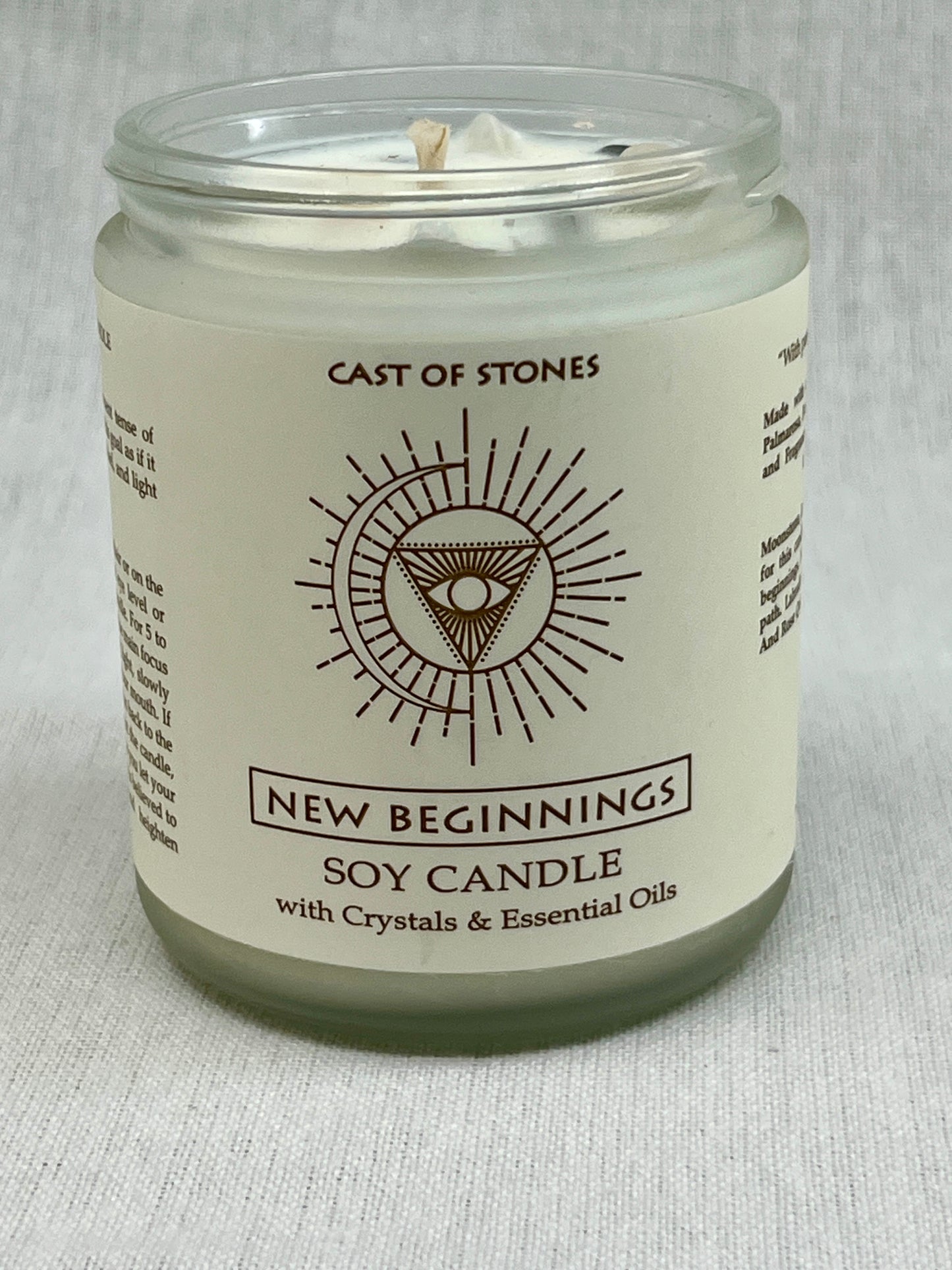 Soy candle in a glass jar with a label on a light gray background