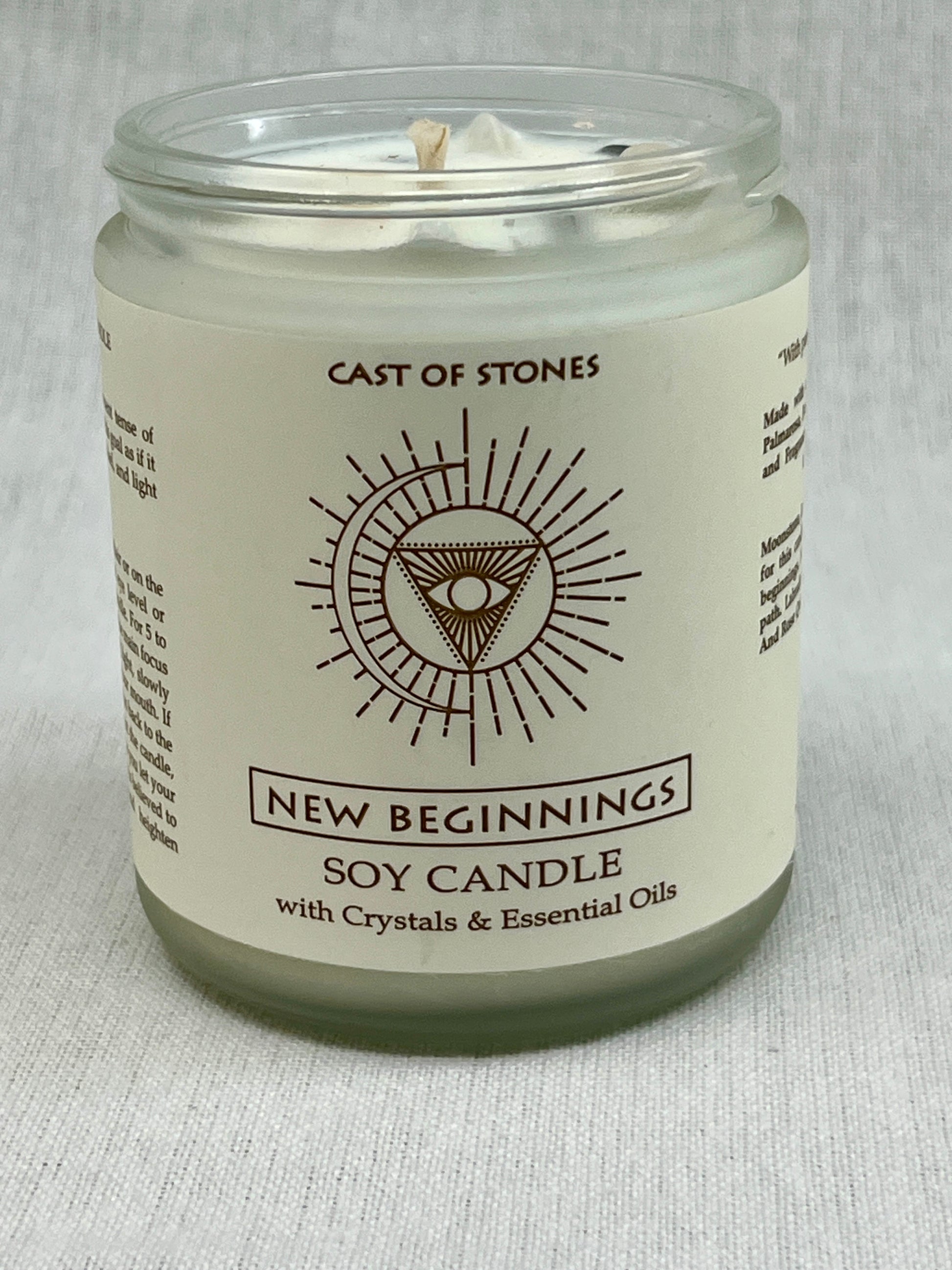 Soy candle in a glass jar with a label on a light gray background