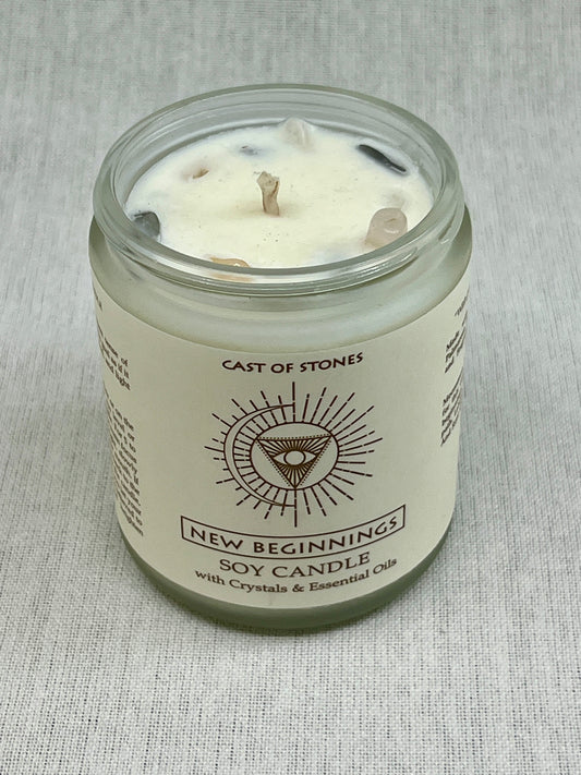 Soy candle in a glass jar with a label on a gray fabric background