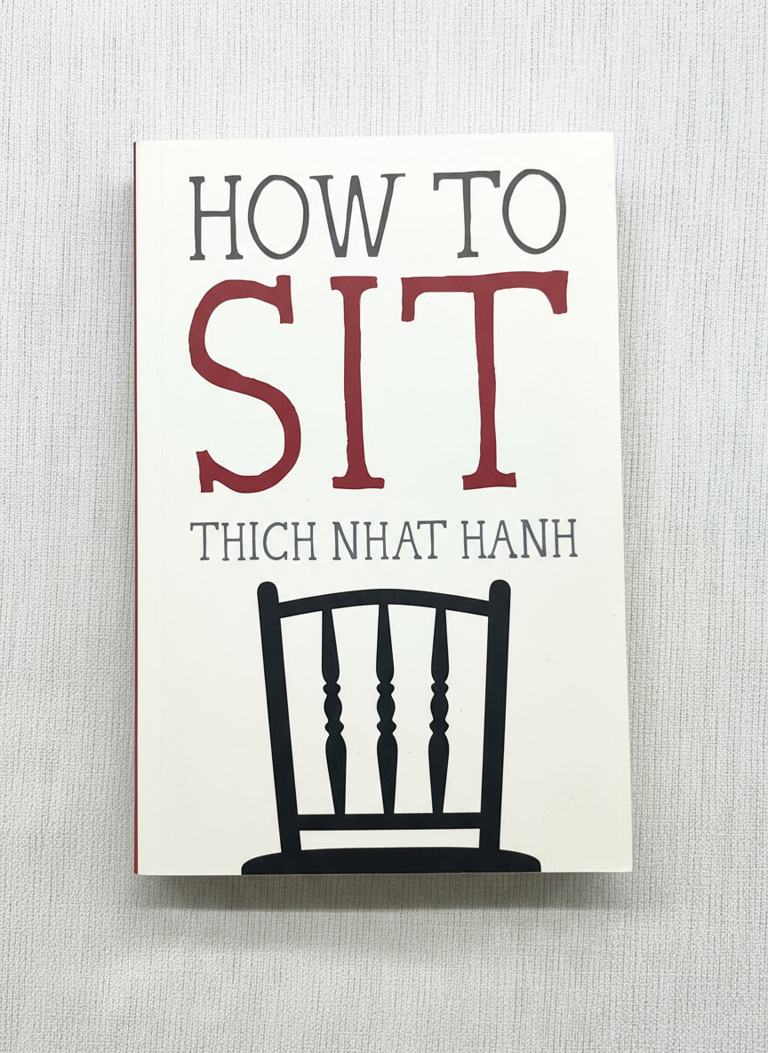 Book cover of 'How to Sit' by Thich Nhat Hanh with a chair illustration on a stand.