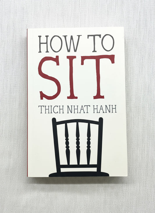 Book cover of 'How to Sit' by Thich Nhat Hanh with a chair illustration on a stand.