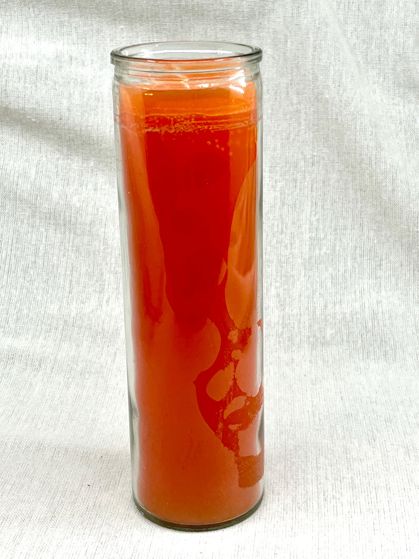 Tall glass container with red liquid on a white background