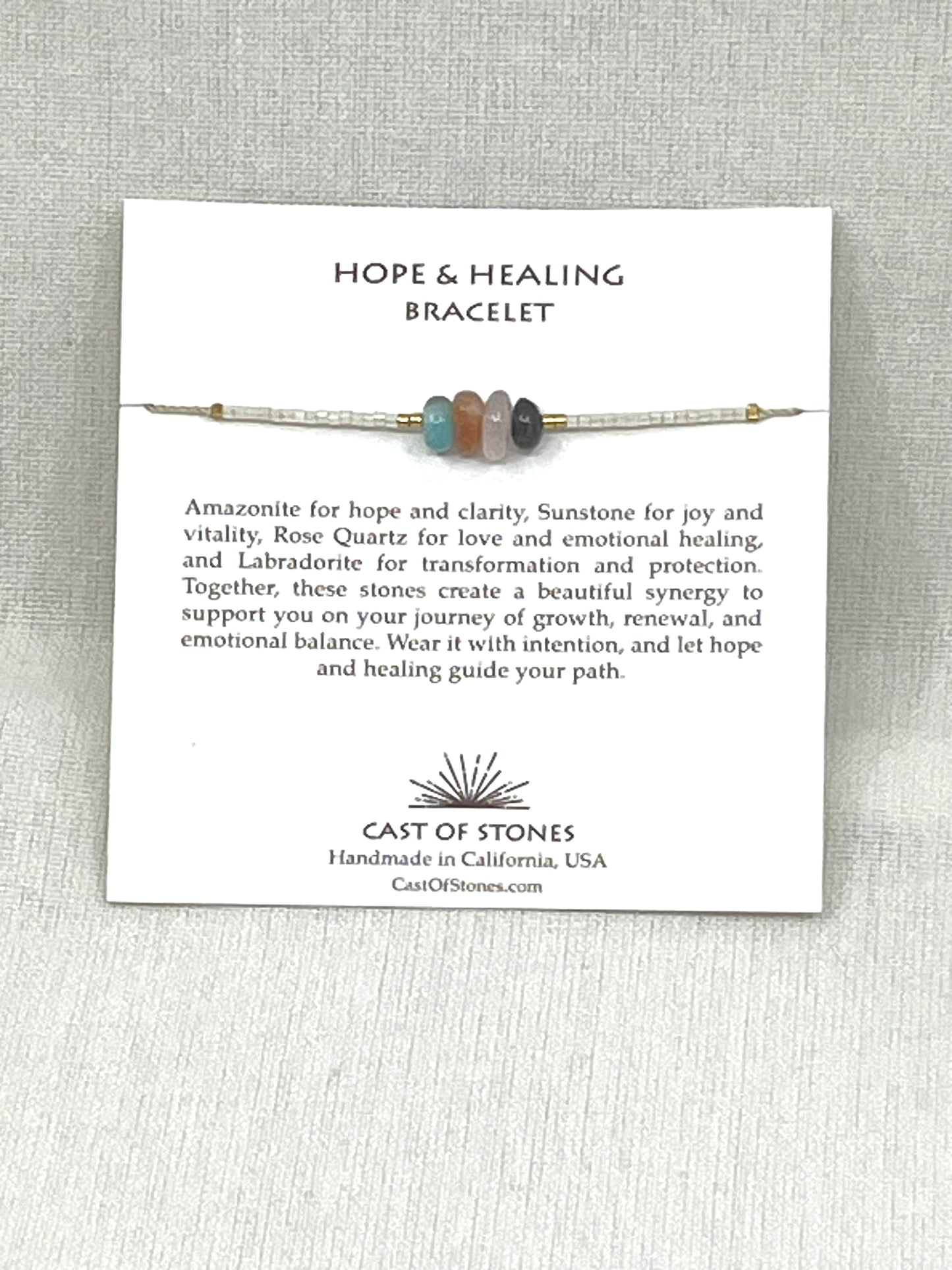 Hope & Healing Bracelet with description card on a gray background