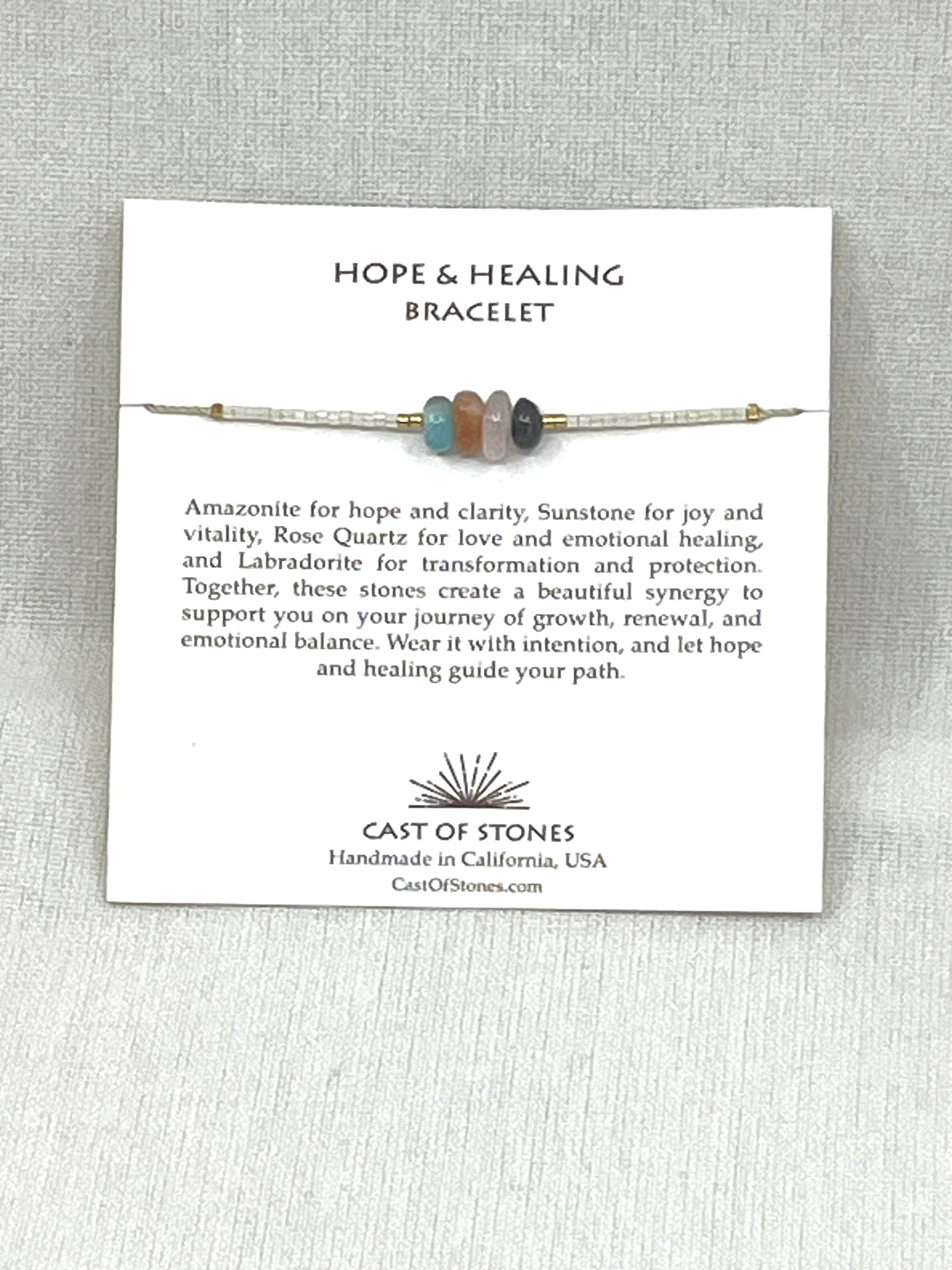 Hope & Healing Bracelet with description card on a gray background