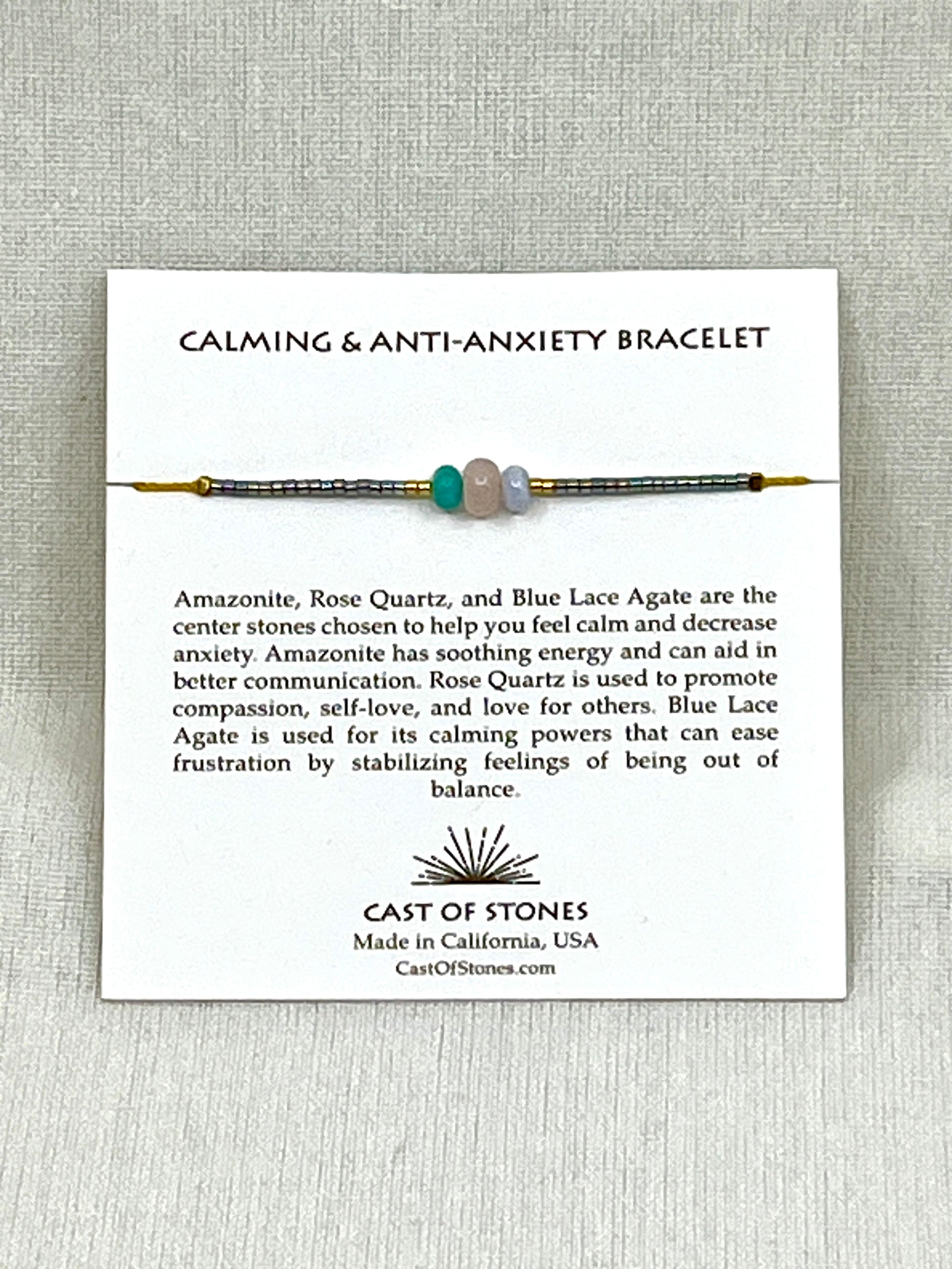 Thee stone bracelet with display card and text on a gray background