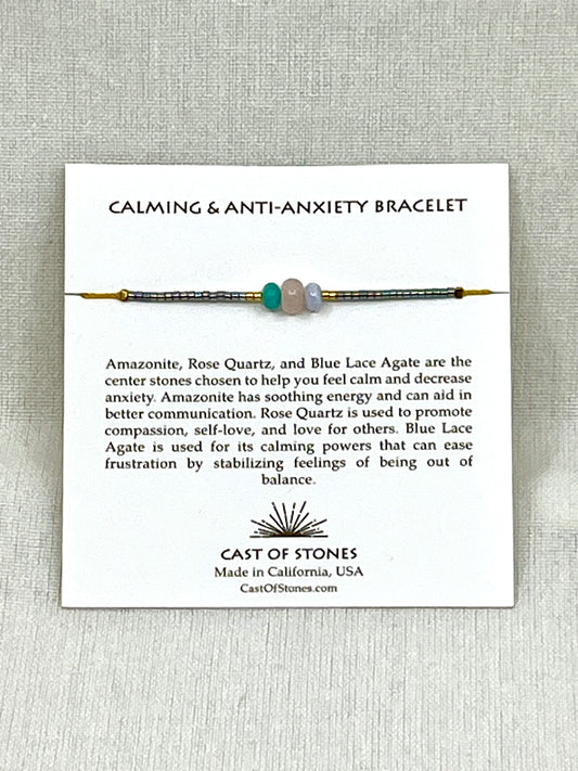 Thee stone bracelet with display card and text on a gray background