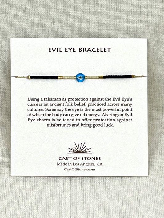 Evil eye bracelet on a card with 'Cast of Stones' branding