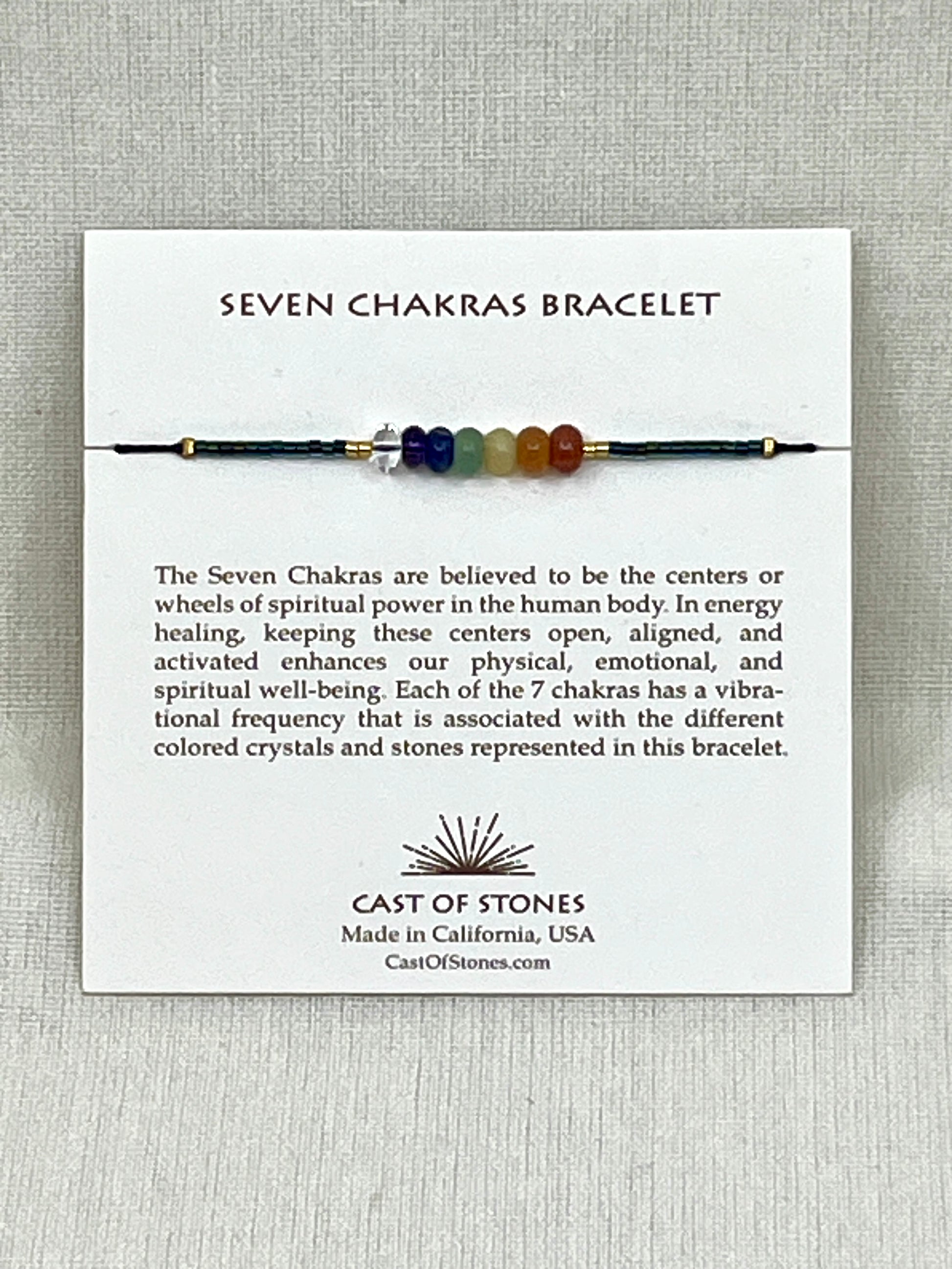 Seven Chakras bracelet on a display card with branding and product description.