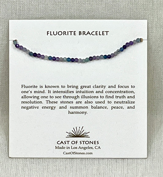 Fluorite bracelet on a card with product description and brand information.