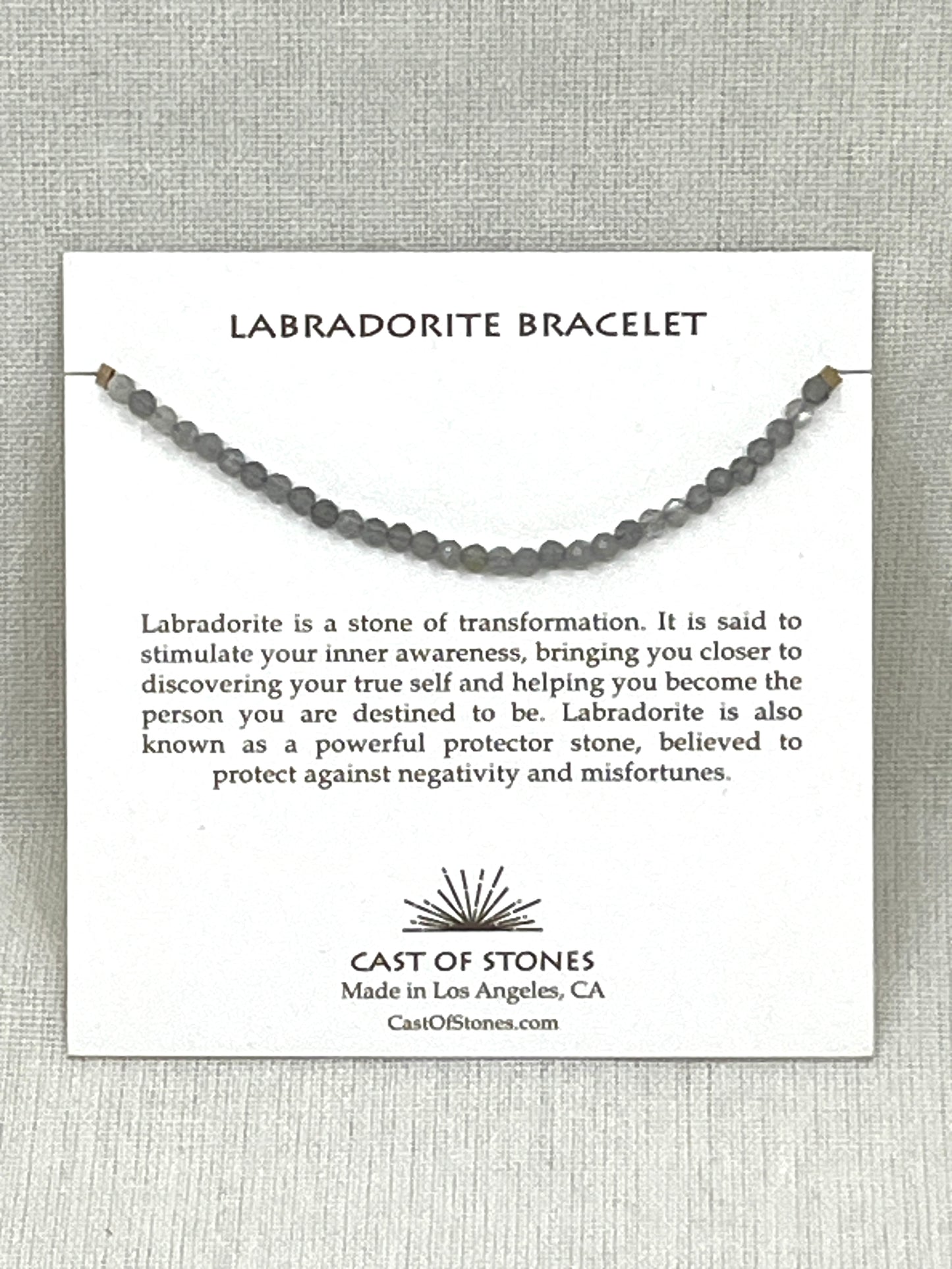 Labradorite bracelet on a display card with information about the stone and brand.