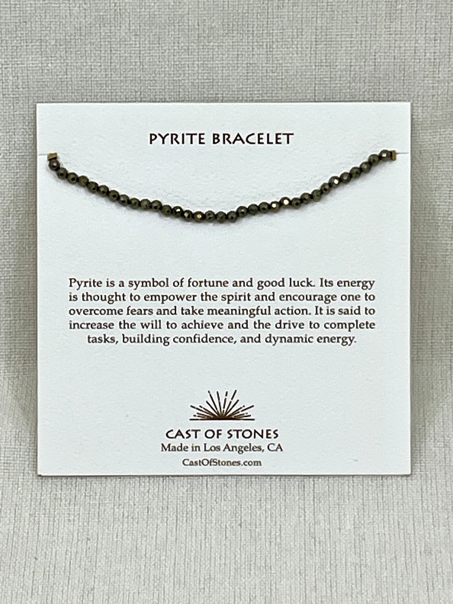 Pyrite bracelet on a card with product description and brand information.