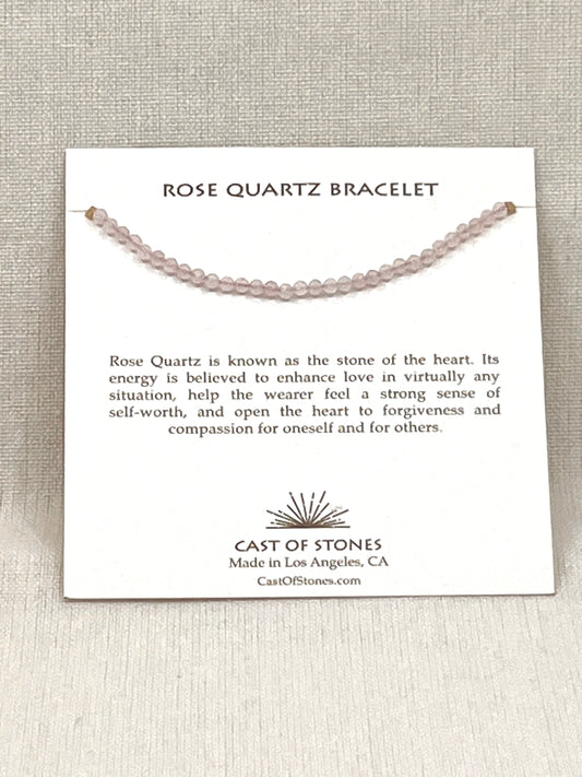 Rose Quartz bracelet on a display card with product description and brand information.