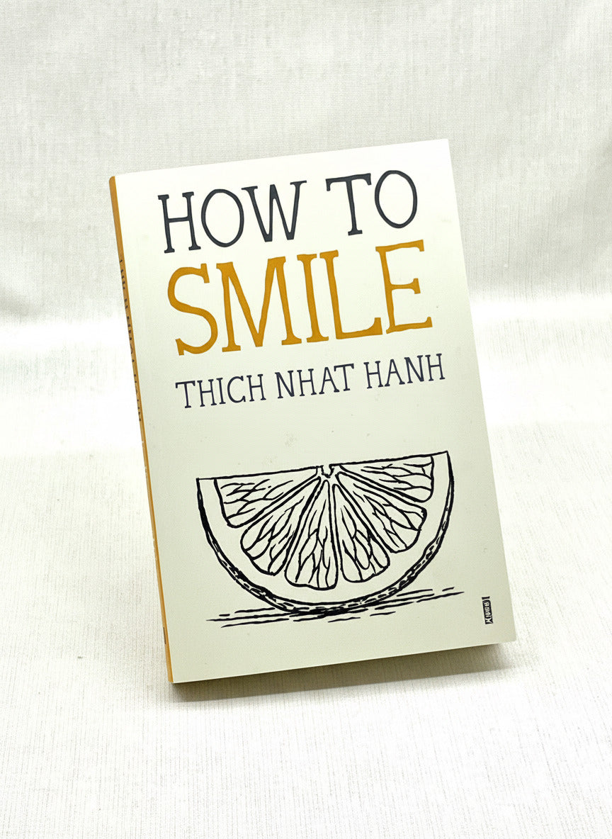 Book titled 'How to Smile' by Thich Nhat Hanh on a light background