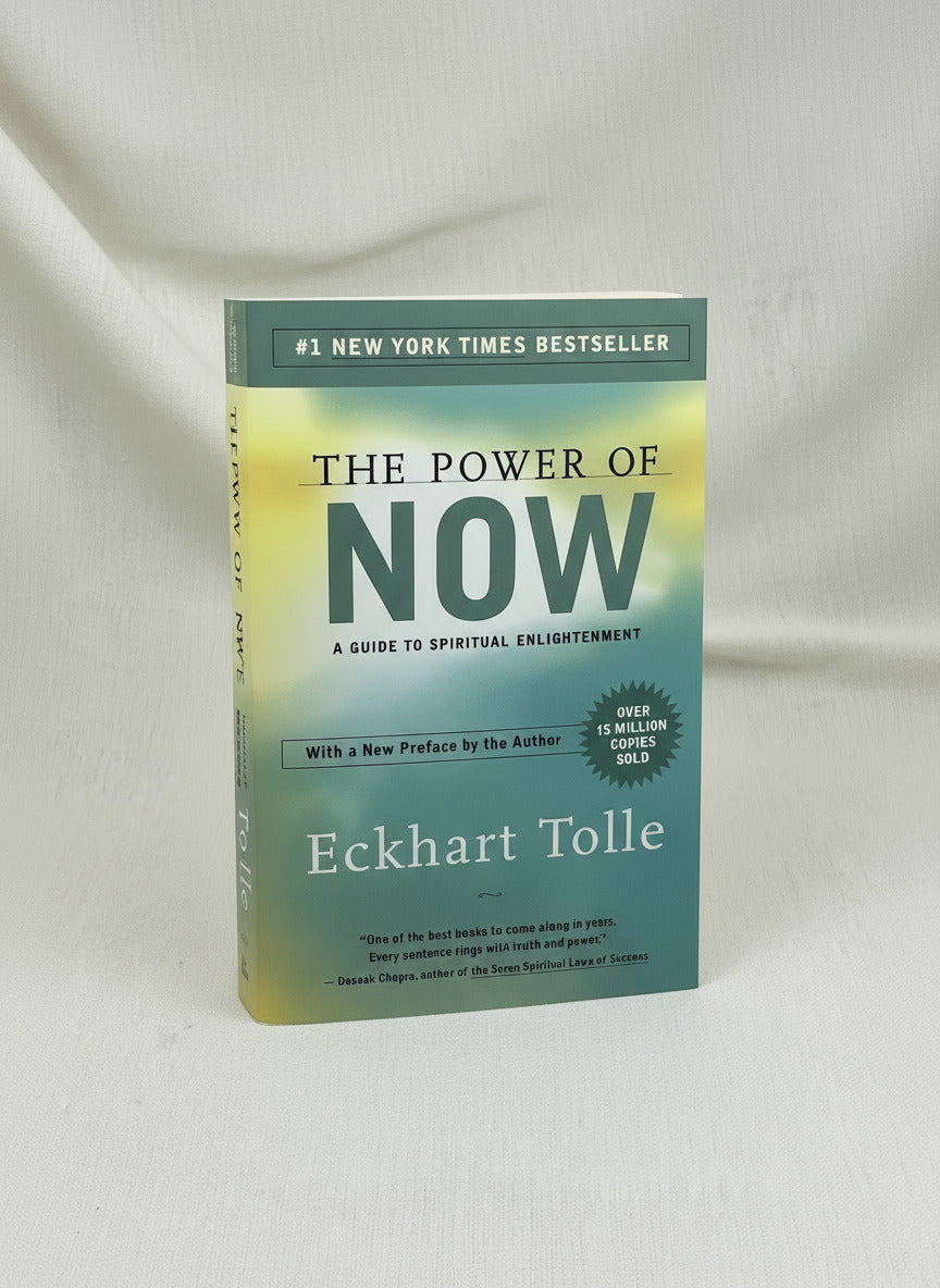 Book titled 'The Power of Now' by Eckhart Tolle on a light background