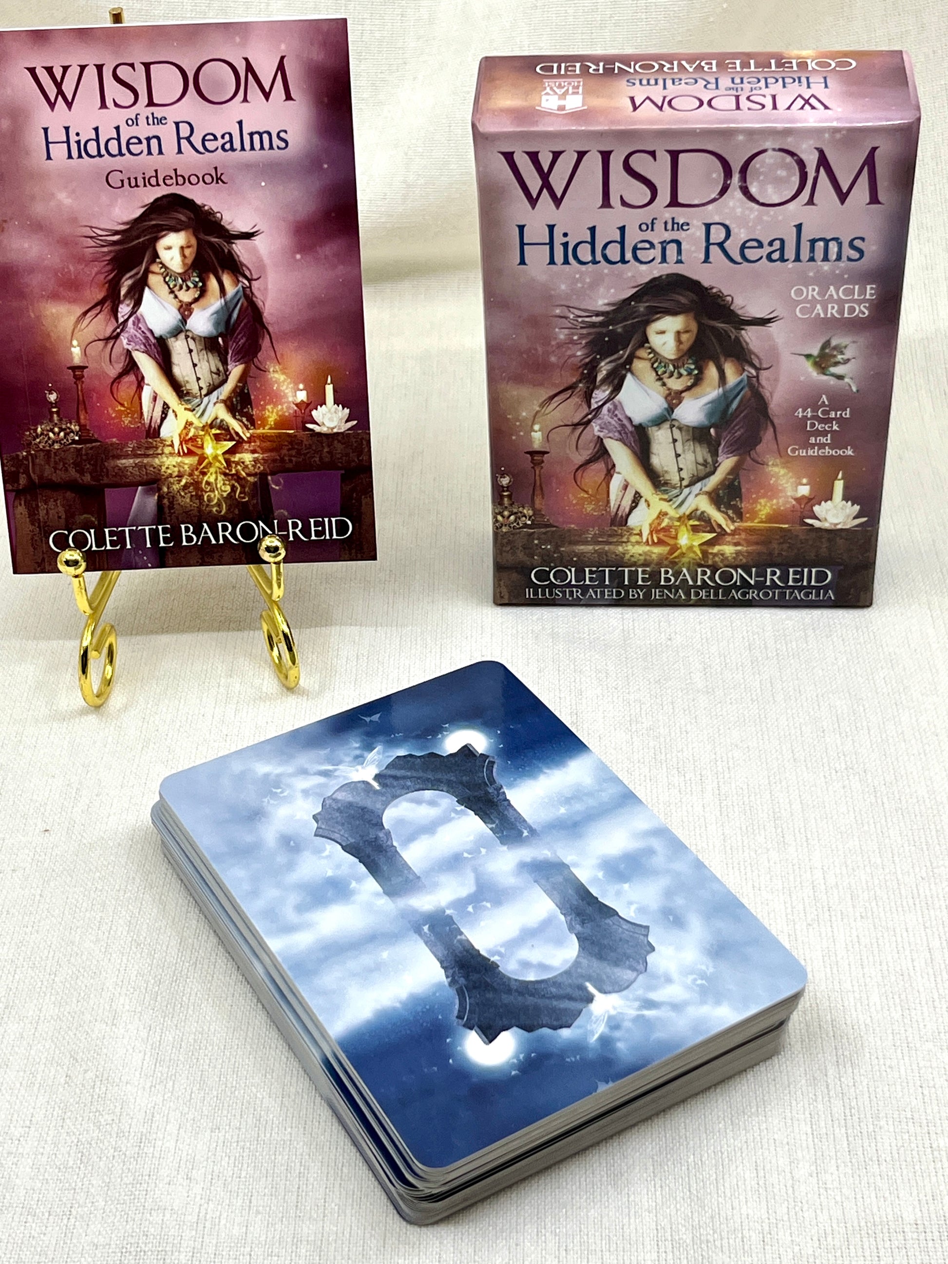 Collection of 'Wisdom of the Hidden Realms' books and cards on a white background