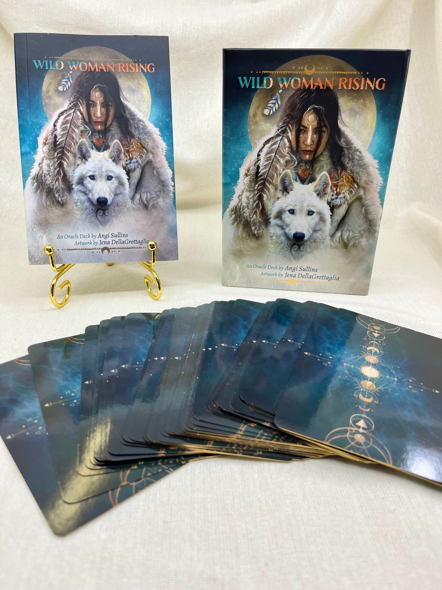 Two 'Wild Woman Rising' card decks with a wolf illustration on a white surface.
