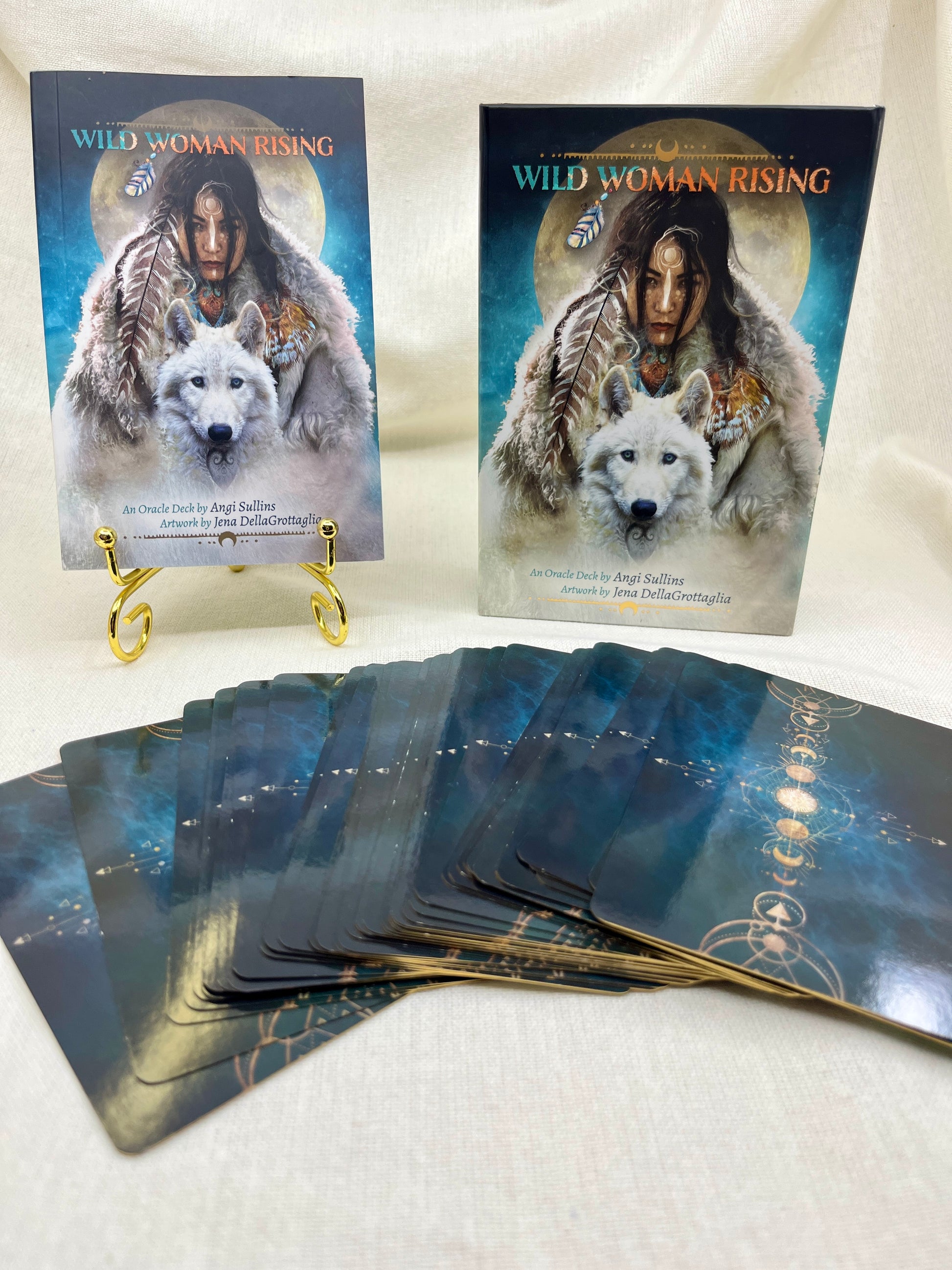 Two 'Wild Woman Rising' card decks with a wolf illustration on a white surface.