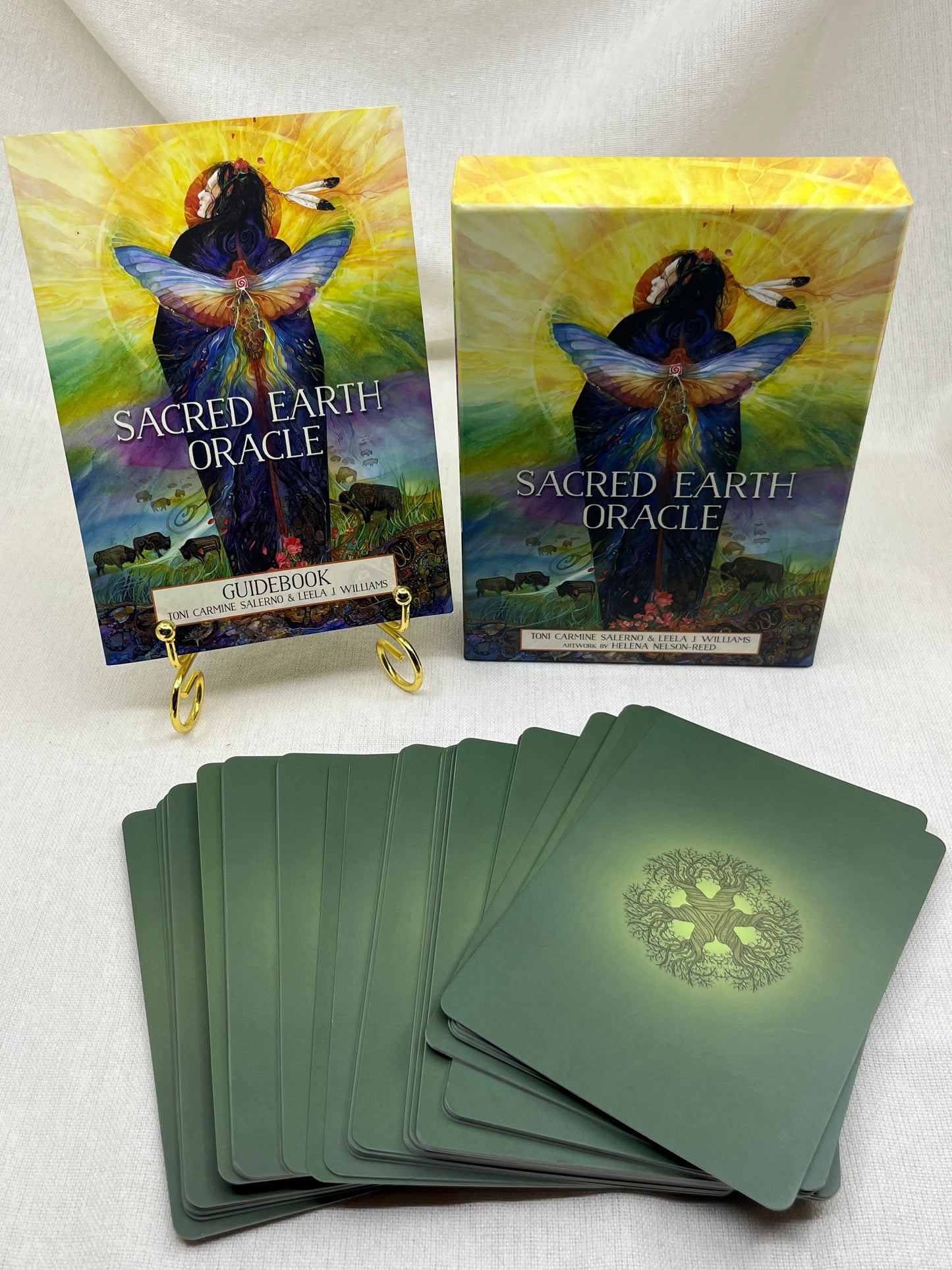 Sacred Earth Oracle cards with colorful box on a white surface