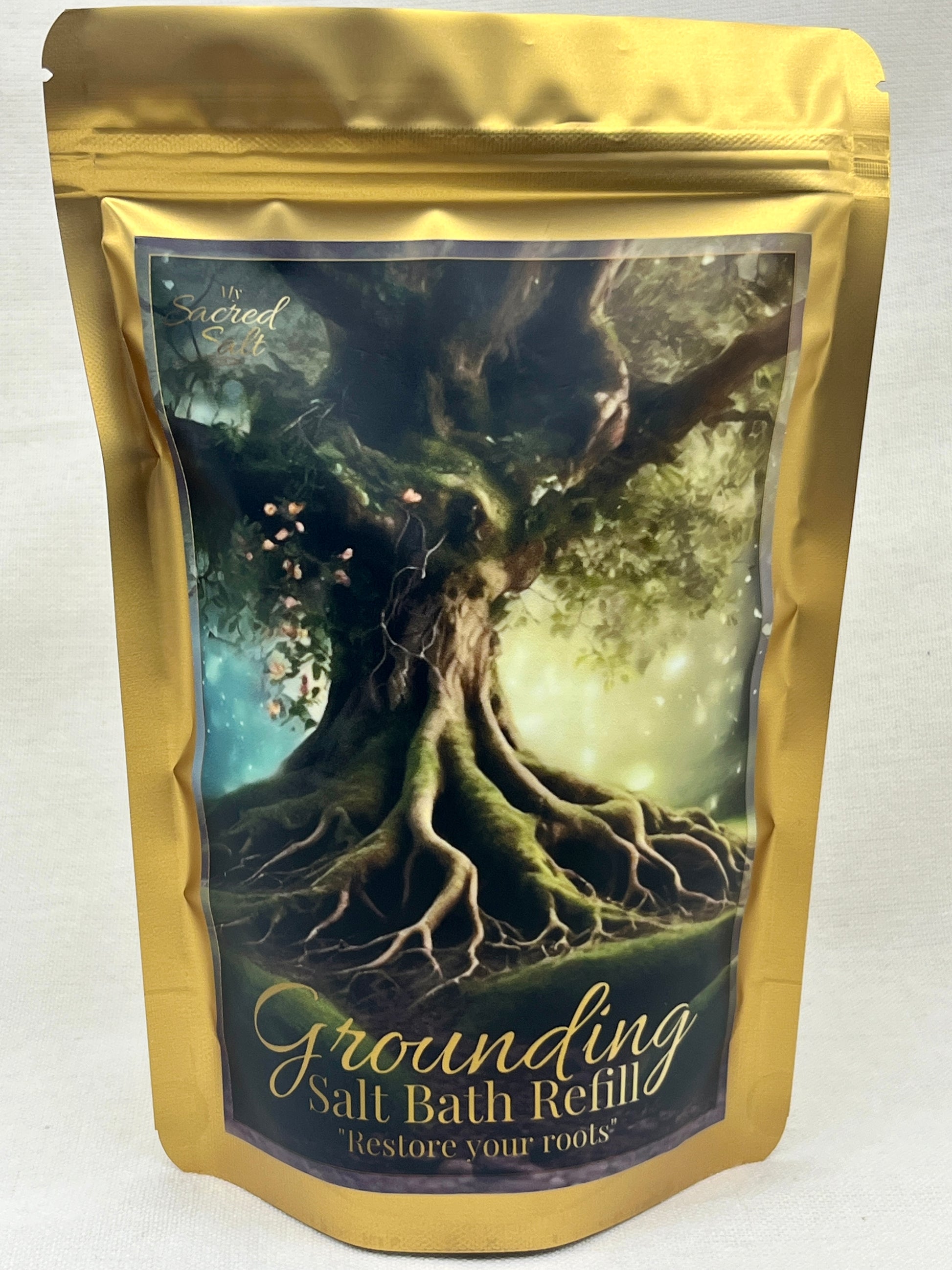 Gold packaging of a 'Grounding Salt Bath Refill' with a tree design on a blue and gold background