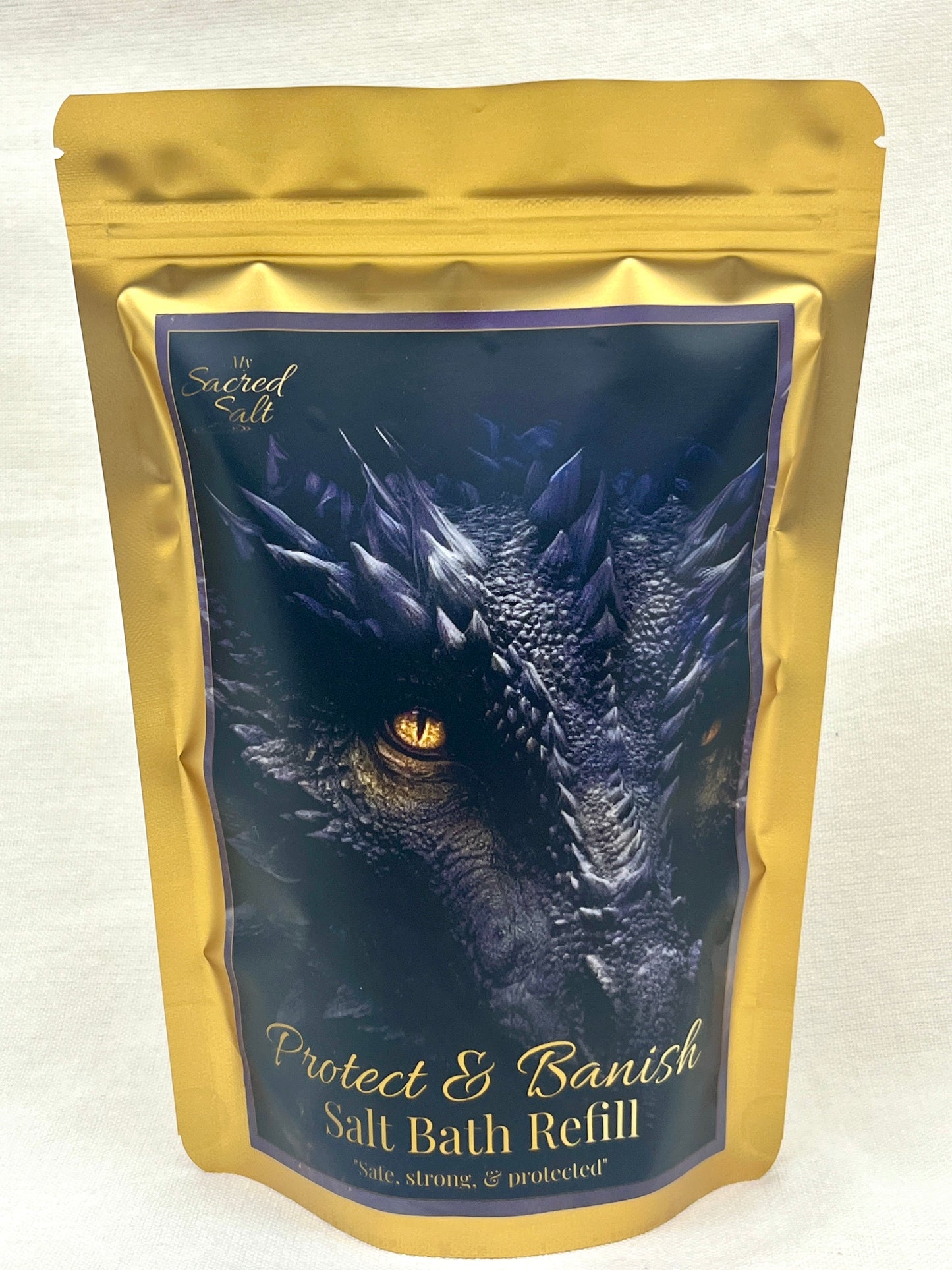 Salt bath refill package with dragon design on a dark background