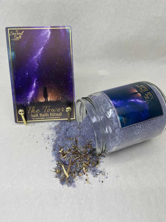 Glass jar with purple contents and a card on a gray surface