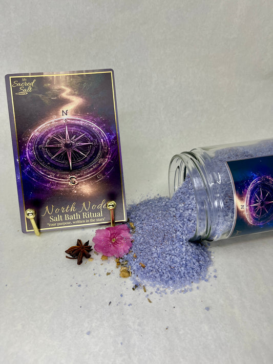 Purple salt bath ritual product with packaging and decorative elements on a light gray background