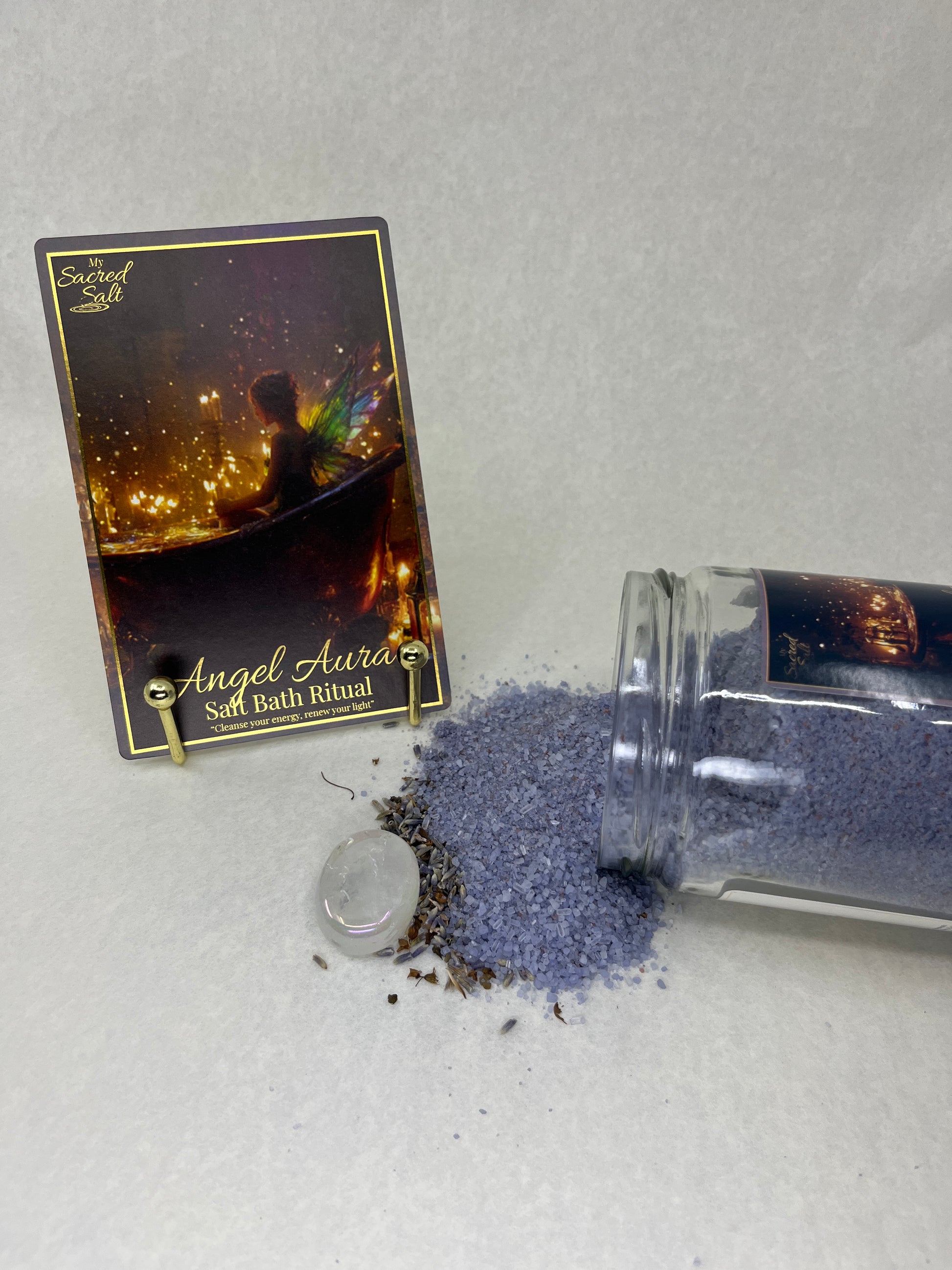 Small bottle of bath salts with a decorative label on a light gray surface